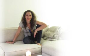 Lara at home on white couch