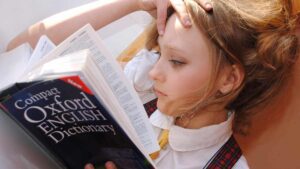 Trauma Sensitive Language blog post - girl reading the dictionary